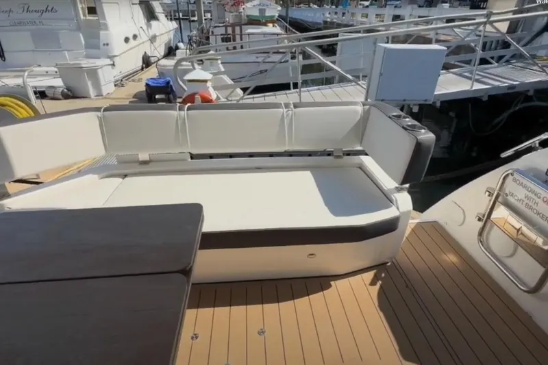 Slide: The Image of 2023 Bavaria R40 Coupe yacht interior with white seating and wooden deck. - 13
