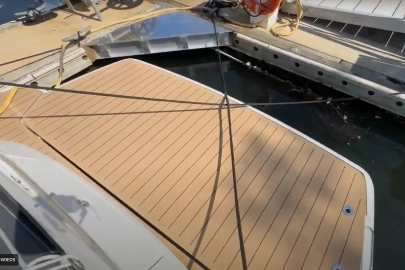 Slide: The Image of 2023 Bavaria R40 Coupe yacht docked with wooden deck and mooring lines. - 15