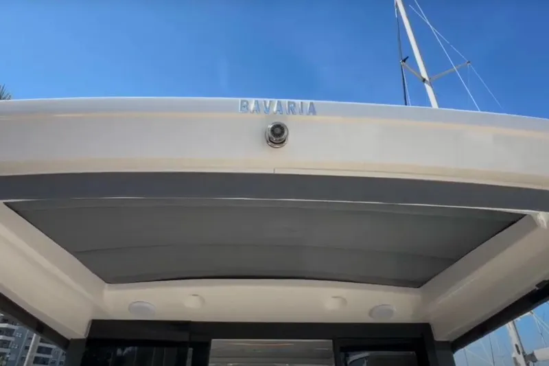 Slide: The Image of 2023 Bavaria R40 Coupe yacht exterior with sleek design under clear blue sky. - 16