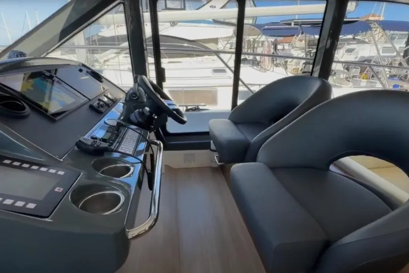 Slide: The Image of Interior of 2023 Bavaria R40 Coupe yacht with modern helm and seating. - 26
