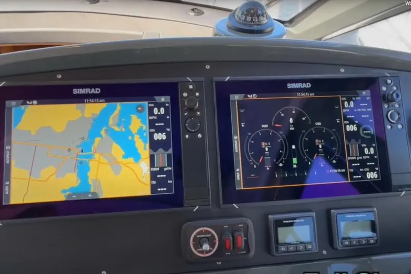 Slide: The Image of 2023 Bavaria R40 Coupe dashboard with dual Simrad navigation displays. - 28