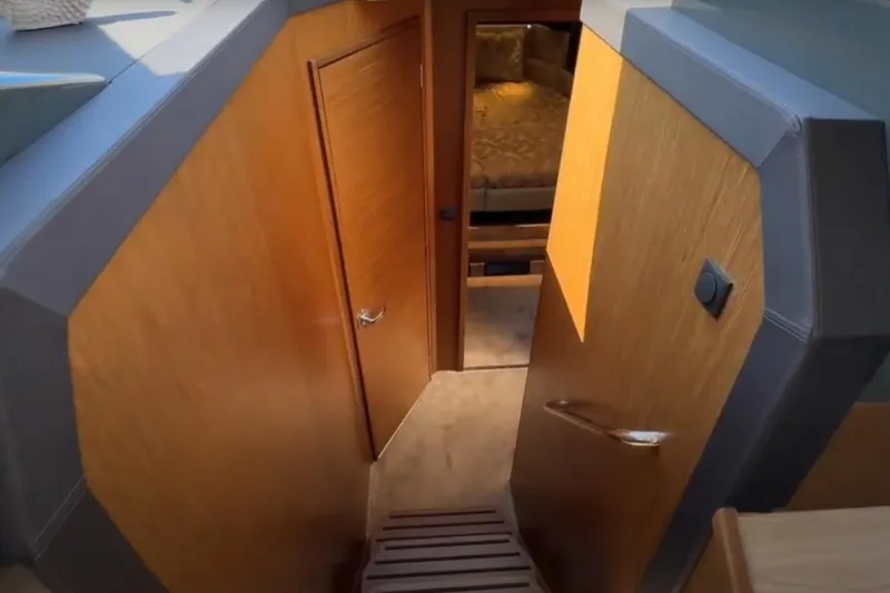 Slide: The Image of Interior view of 2023 Bavaria R40 Coupe, featuring wooden doors and cozy cabin space. - 30