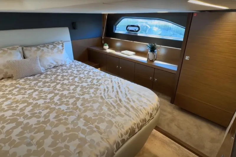 Slide: The Image of Luxurious bedroom interior of 2023 Bavaria R40 Coupe yacht with elegant bedding and wood accents. - 34