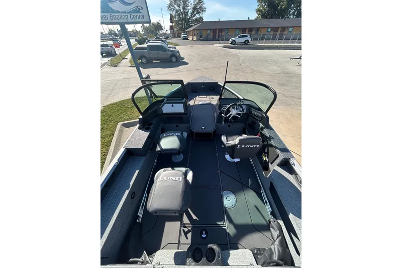 Slide: The Image of 2026 Lund 1875 Impact XS Sport boat on trailer, covered, parked outdoors. - 10