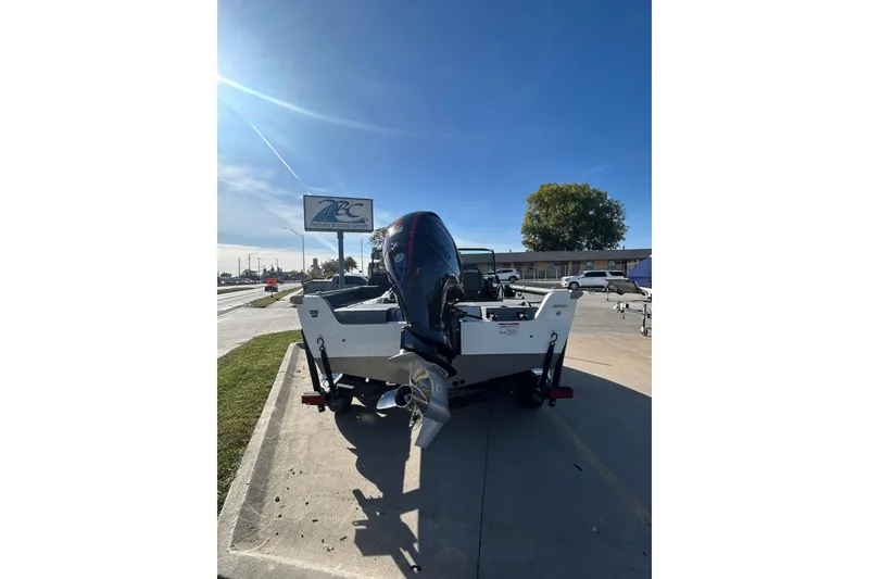 Slide: The Image of 2026 Lund 1875 Impact XS Sport boat interior with seating and dashboard view. - 15