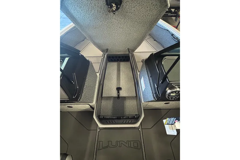 Slide: The Image of 2026 Lund 1875 Impact XS Sport boat with outboard motor in parking lot. - 19