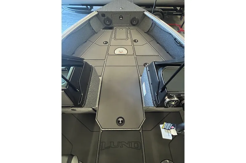 Slide: The Image of 2026 Lund 1875 Impact XS Sport boat on trailer under bright sun. - 21