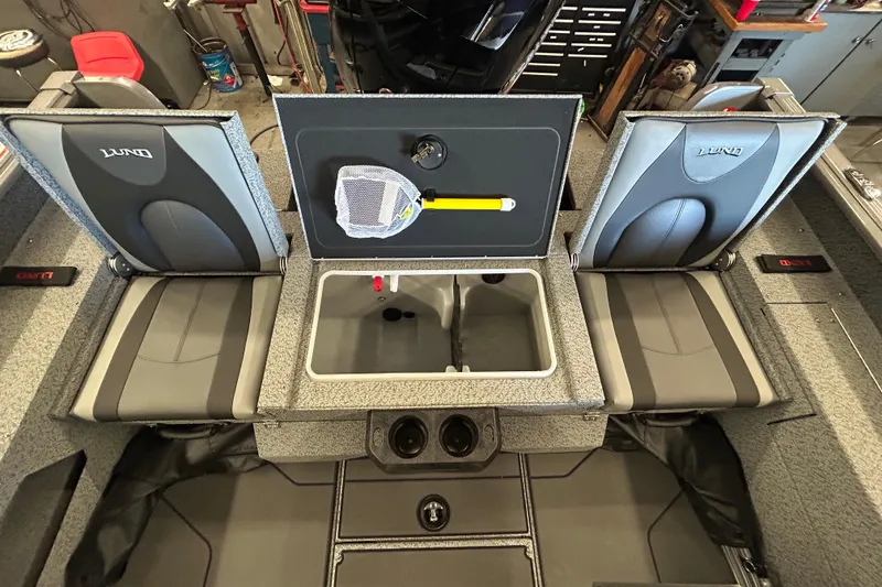 Slide: The Image of 2026 Lund 1875 Impact XS Sport boat interior, featuring storage compartments and sleek design. - 25