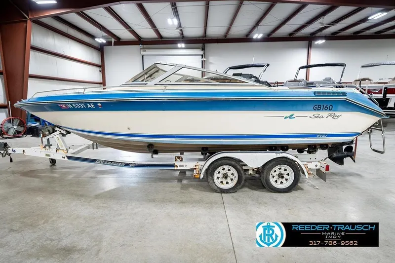 Slide: The Image of 1987 Sea Ray Sorrento 21 boat on trailer in indoor showroom. - 10