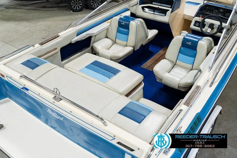 Slide: The Image of 1987 Sea Ray Sorrento 21 boat interior with blue and white seating, steering wheel, and dashboard. - 13