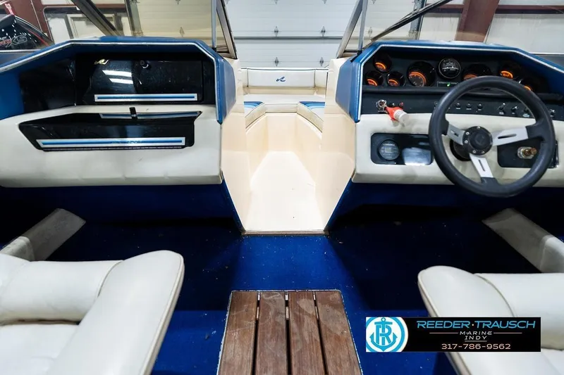 Slide: The Image of Interior of a 1987 Sea Ray Sorrento 21 boat with blue and white seating. - 16