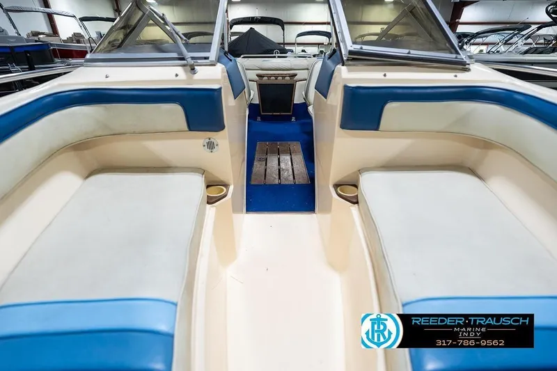 Slide: The Image of 1987 Sea Ray Sorrento 21 boat interior with blue and white seating, showcased at Reeder-Trausch Marine. - 18