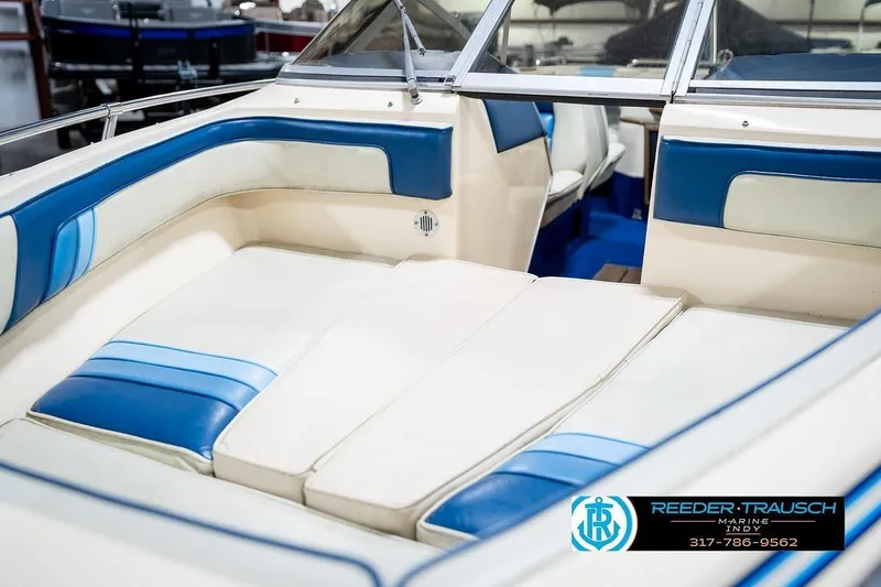 Slide: The Image of 1987 Sea Ray Sorrento 21 boat interior with blue and white seating, Reeder-Trausch Marine logo. - 21