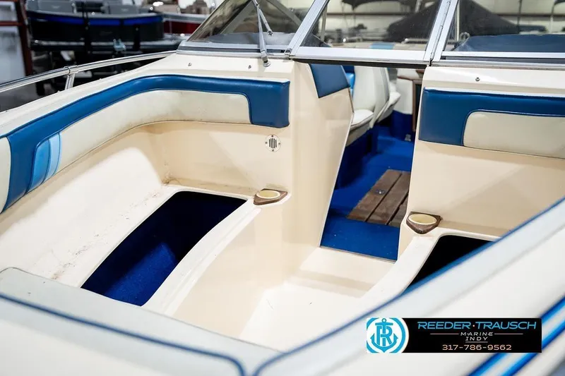 Slide: The Image of 1987 Sea Ray Sorrento 21 boat interior with blue and white seating, showcased by Reeder-Trausch Marine. - 23