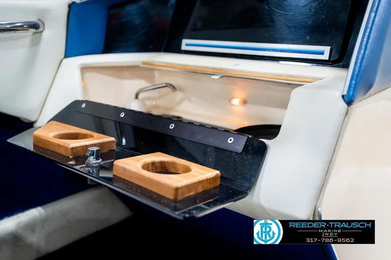 Slide: The Image of 1987 Sea Ray Sorrento 21 dashboard with cup holders and storage compartment. - 25