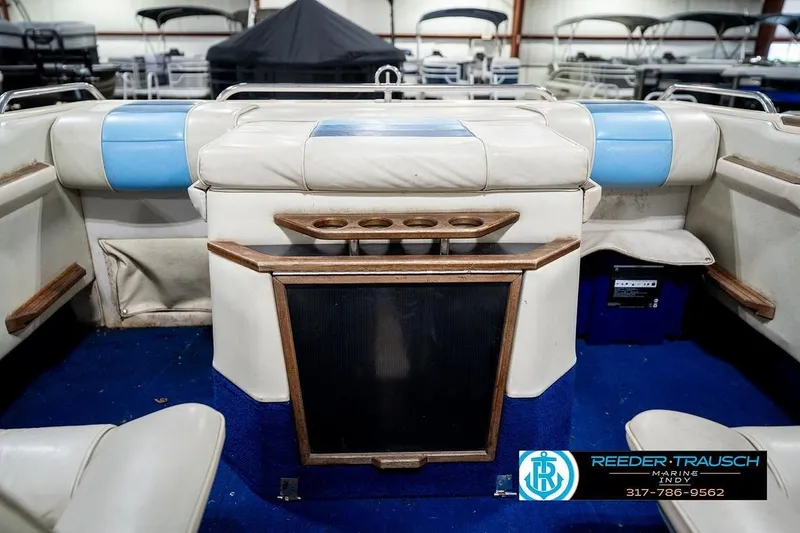 Slide: The Image of Interior of a 1987 Sea Ray Sorrento 21 boat with blue and white seating. - 28