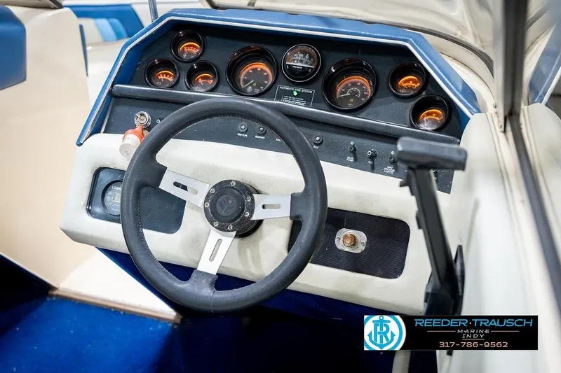 Slide: The Image of 1987 Sea Ray Sorrento 21 dashboard with steering wheel and gauges, featuring Reeder-Trausch Marine logo. - 30