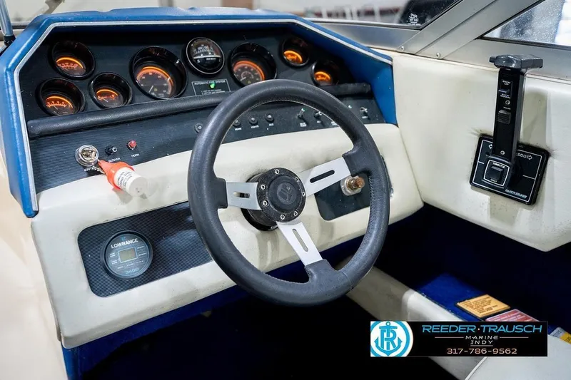 Slide: The Image of 1987 Sea Ray Sorrento 21 dashboard with steering wheel and control panel. - 31