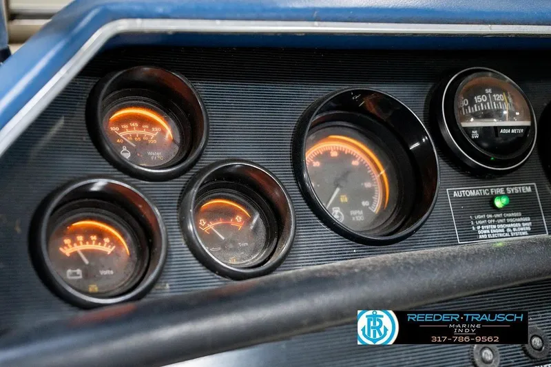 Slide: The Image of Dashboard gauges of a 1987 Sea Ray Sorrento 21 boat, featuring illuminated dials. - 34