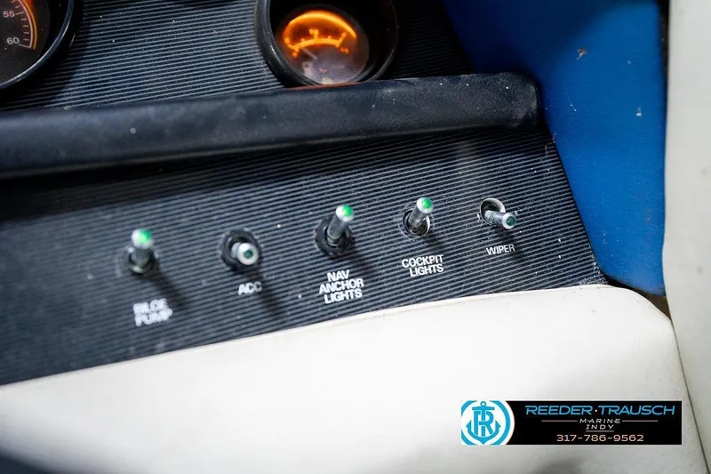 Slide: The Image of 1987 Sea Ray Sorrento 21 dashboard with switches for bilge pump, lights, and wiper. - 36