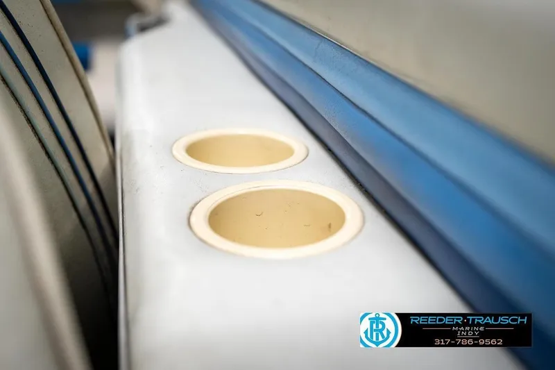 Slide: The Image of 1987 Sea Ray Sorrento 21 boat interior with cup holders, featuring blue and white upholstery. - 38