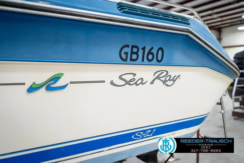 Slide: The Image of 1987 Sea Ray Sorrento 21 boat with blue and white design in a showroom. - 43