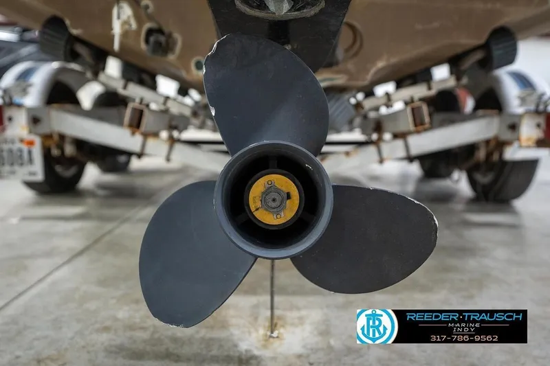 Slide: The Image of Close-up of a 1987 Sea Ray Sorrento 21 boat propeller in a garage. - 46