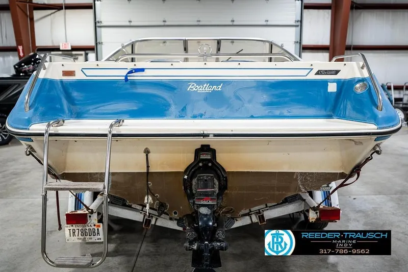 Slide: The Image of 1987 Sea Ray Sorrento 21 boat in a garage, rear view with ladder and motor. - 8