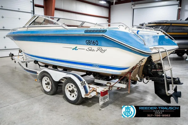 Slide: The Image of 1987 Sea Ray Sorrento 21 boat on trailer in indoor storage facility. - 9
