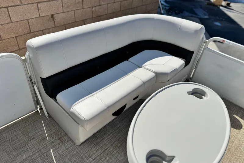 Slide: The Image of Luxurious seating on 2020 SunCatcher V24 SS pontoon boat with table and cup holders. - 11