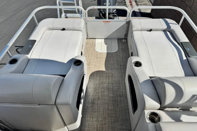 Slide: The Image of 2020 SunCatcher V24 SS pontoon boat interior with plush seating and cup holders. - 16