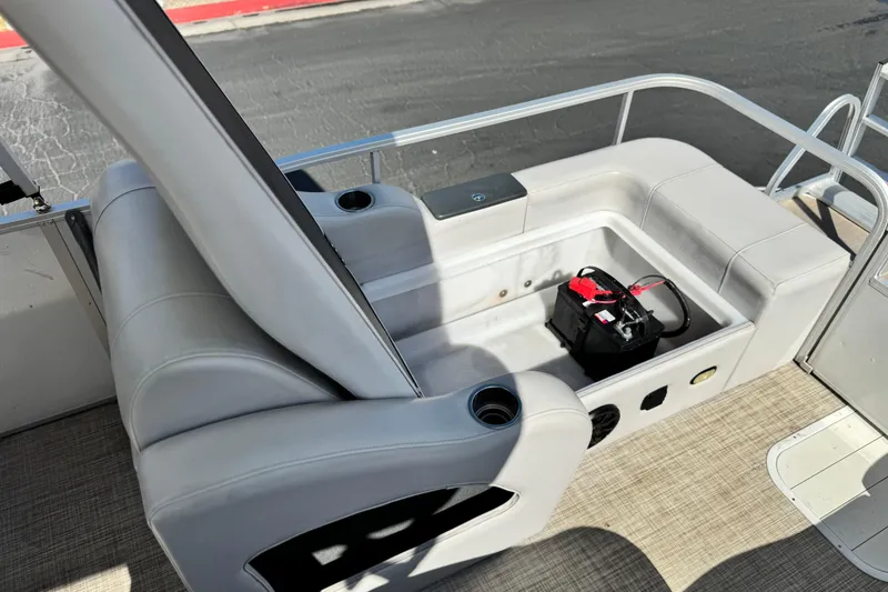 Slide: The Image of 2020 SunCatcher V24 SS boat interior with storage compartment and battery. - 18