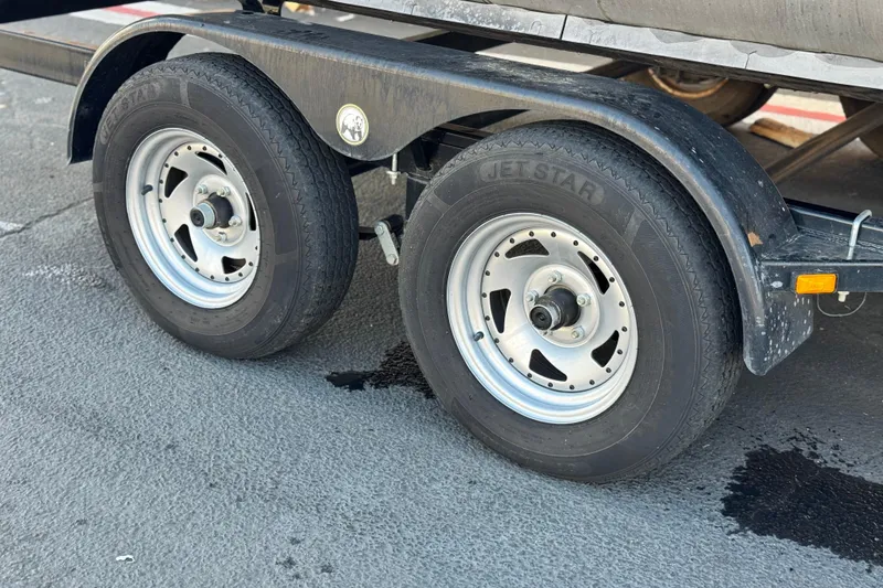 Slide: The Image of Trailer wheels of a 2020 SunCatcher V24 SS on pavement. - 26