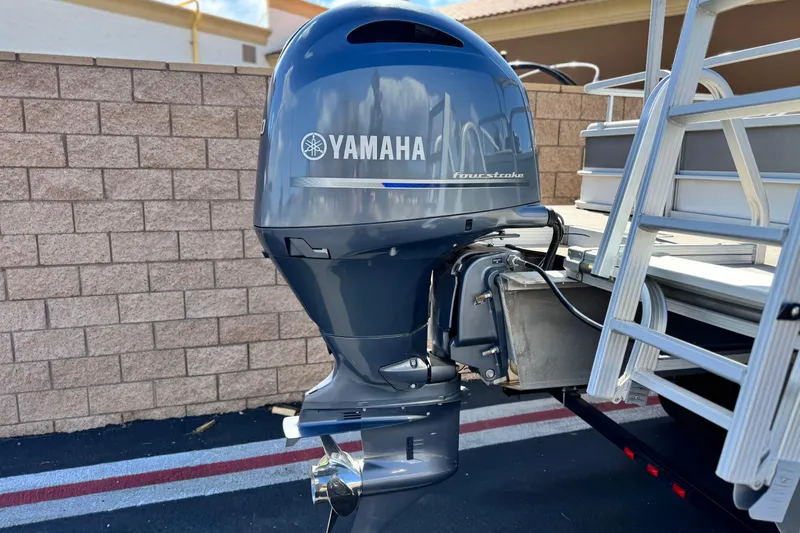 Slide: The Image of Yamaha outboard motor on 2020 SunCatcher V24 SS pontoon boat, parked by brick wall. - 7