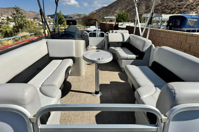 Slide: The Image of 2020 SunCatcher V24 SS pontoon boat interior with spacious seating and table. - 9