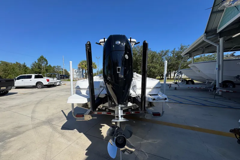 Slide: The Image of 2026 Caymas 26 HB boat on trailer, parked outdoors under clear blue sky. - 13