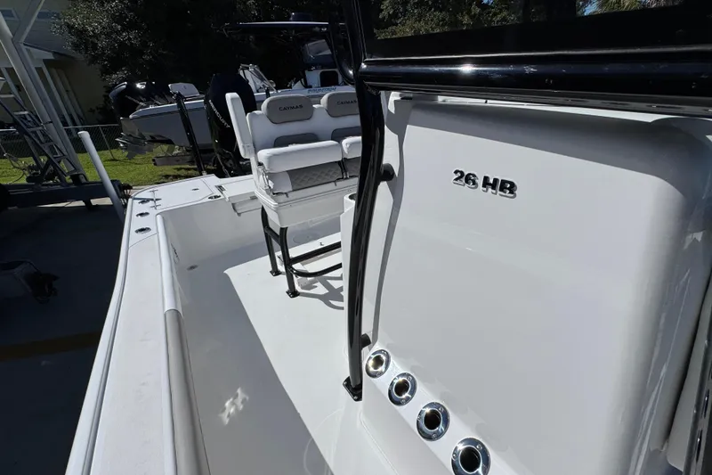 Slide: The Image of 2026 Caymas 26 HB boat interior with seating and console details. - 23