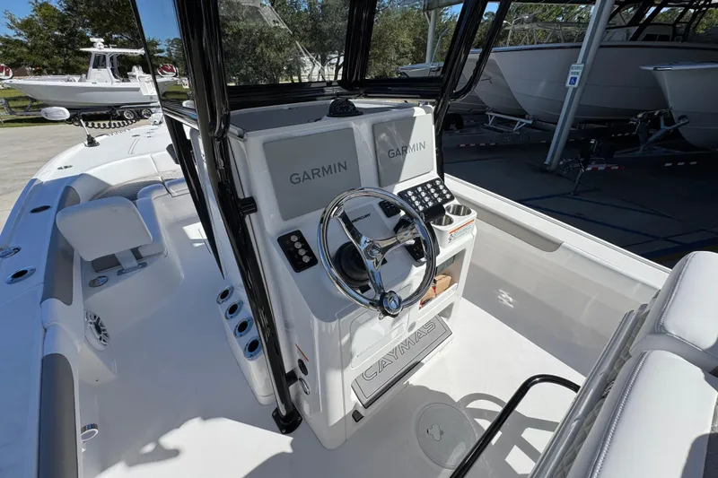 Slide: The Image of 2026 Caymas 26 HB boat interior with Garmin navigation system and sleek steering console. - 27