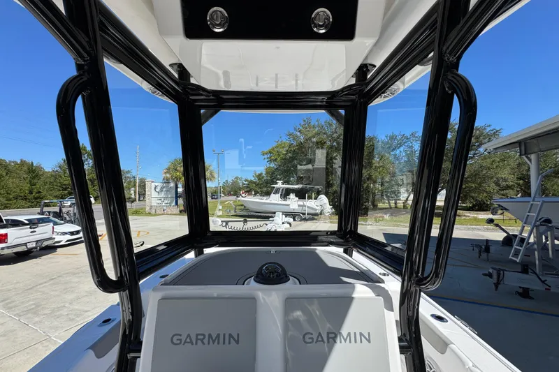 Slide: The Image of 2026 Caymas 26 HB boat interior with Garmin navigation, docked outdoors. - 29