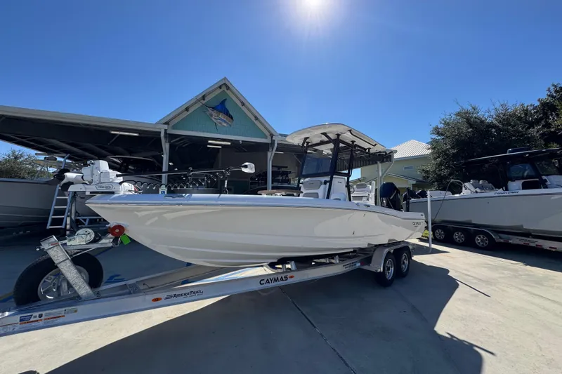 Slide: The Image of 2026 Caymas 26 HB boat on trailer under clear blue sky. - 3
