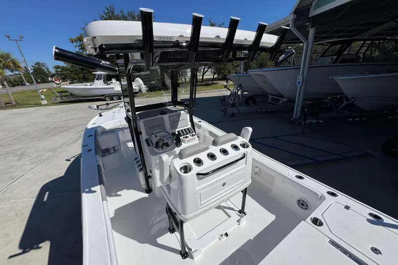 Slide: The Image of 2026 Caymas 26 HB boat with modern console and seating, docked outdoors. - 31