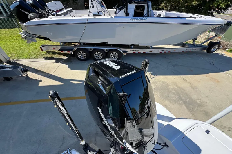 Slide: The Image of 2026 Caymas 26 HB boat with Mercury engines on a trailer, parked outdoors. - 36