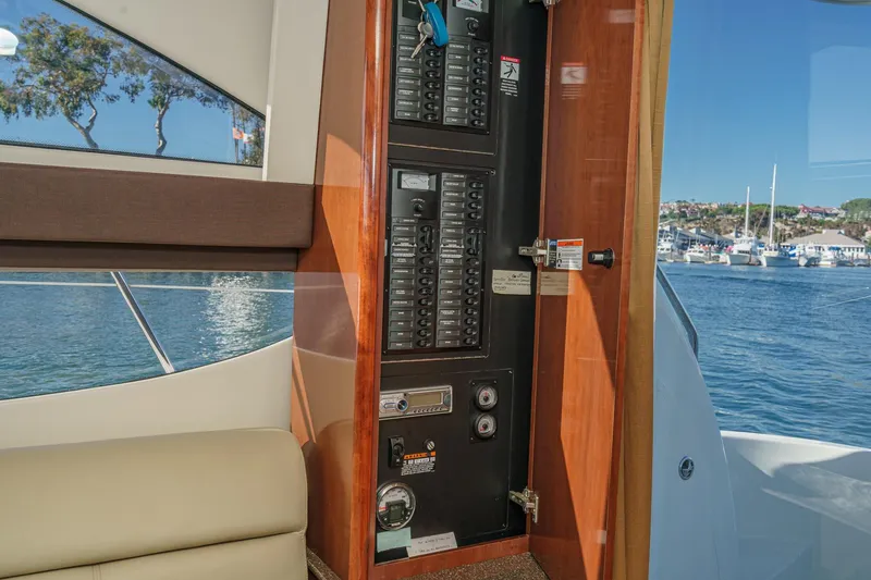 Slide: The Image of Interior view of 2011 Meridian 341 Sedan yacht with control panel and scenic marina backdrop. - 23