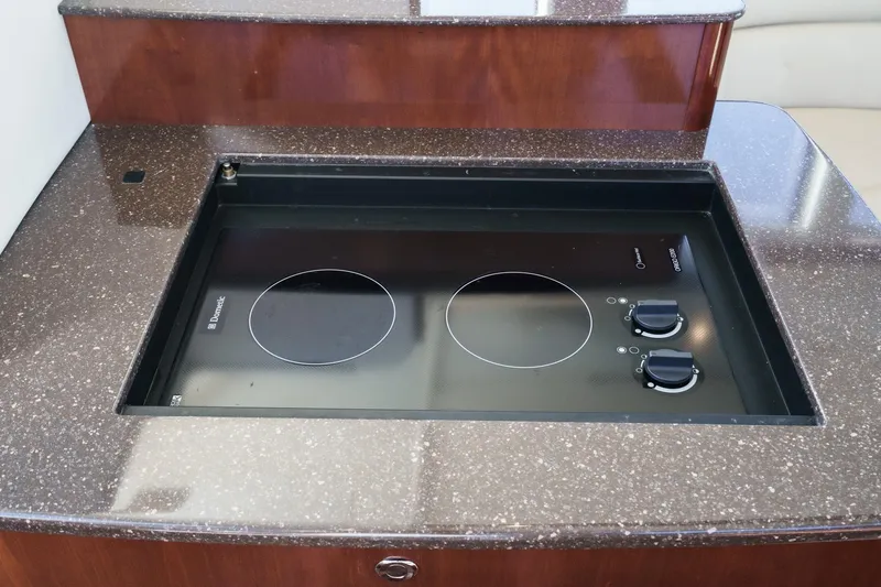 Slide: The Image of Built-in stovetop on 2011 Meridian 341 Sedan yacht, featuring dual burners and sleek countertop. - 28