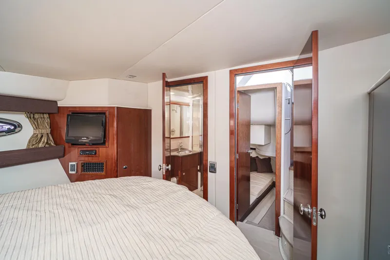 Slide: The Image of 2011 Meridian 341 Sedan interior with cozy bedroom, TV, and bathroom access. - 33