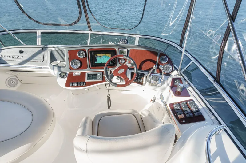 Slide: The Image of 2011 Meridian 341 Sedan helm with navigation controls and ocean view. - 6