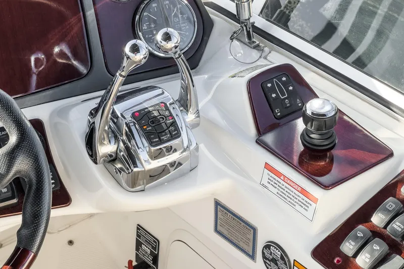 Slide: The Image of 2011 Meridian 341 Sedan helm controls with dual throttle levers and navigation instruments. - 9