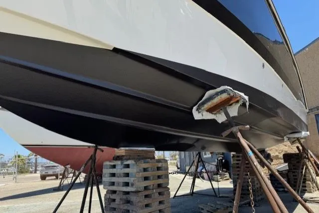 Slide: The Image of 2010 Bayliner 255 Cruiser on blocks, undergoing maintenance in a boatyard. - 10