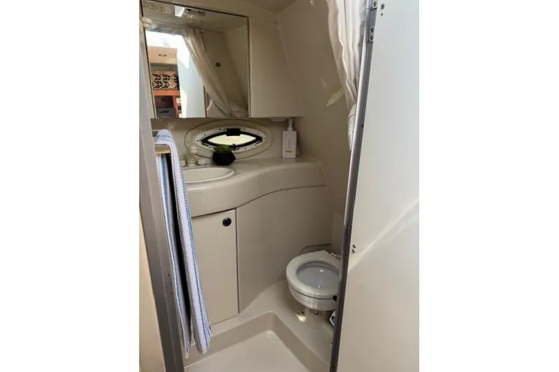 Slide: The Image of 2010 Bayliner 255 Cruiser bathroom with sink, mirror, and toilet. - 22
