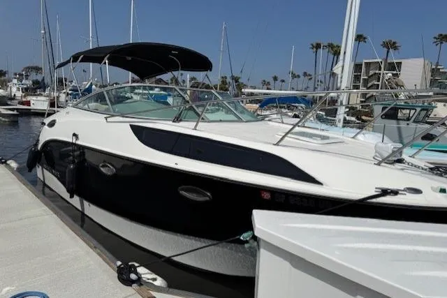 Slide: The Image of 2010 Bayliner 255 Cruiser docked at a marina under clear blue skies. - 23